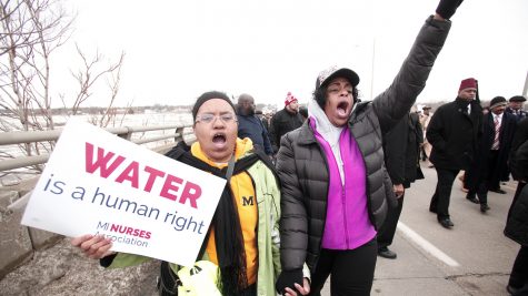 People participate in a national mile-long march in February to highlight the push for clean water in Flint, Mich.