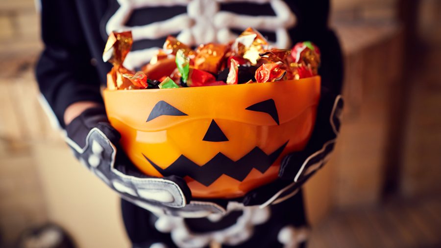 Boy+in+skeleton+costume+holding+bowl+full+of+candies